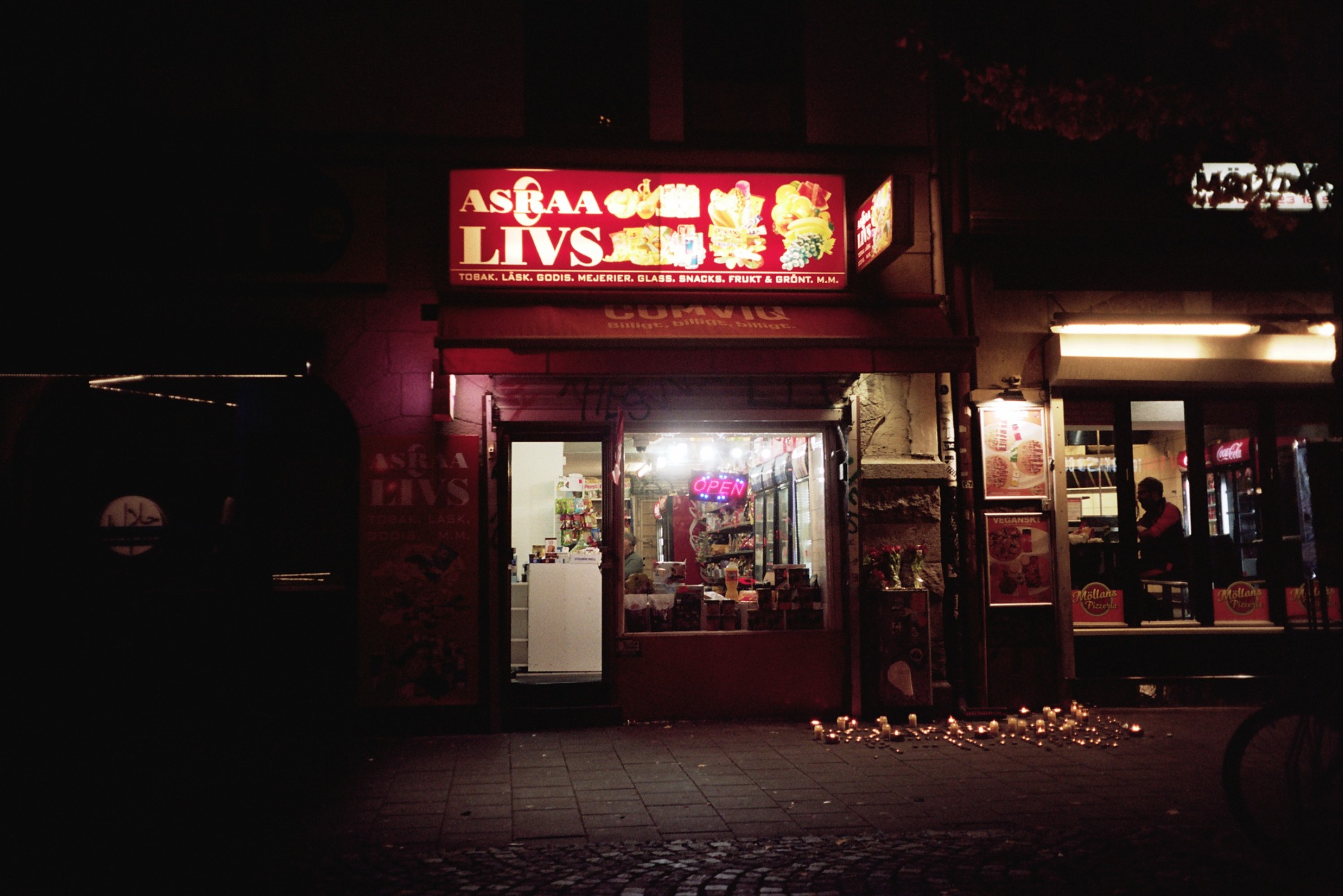 Photo of a convenience store with a bright sign